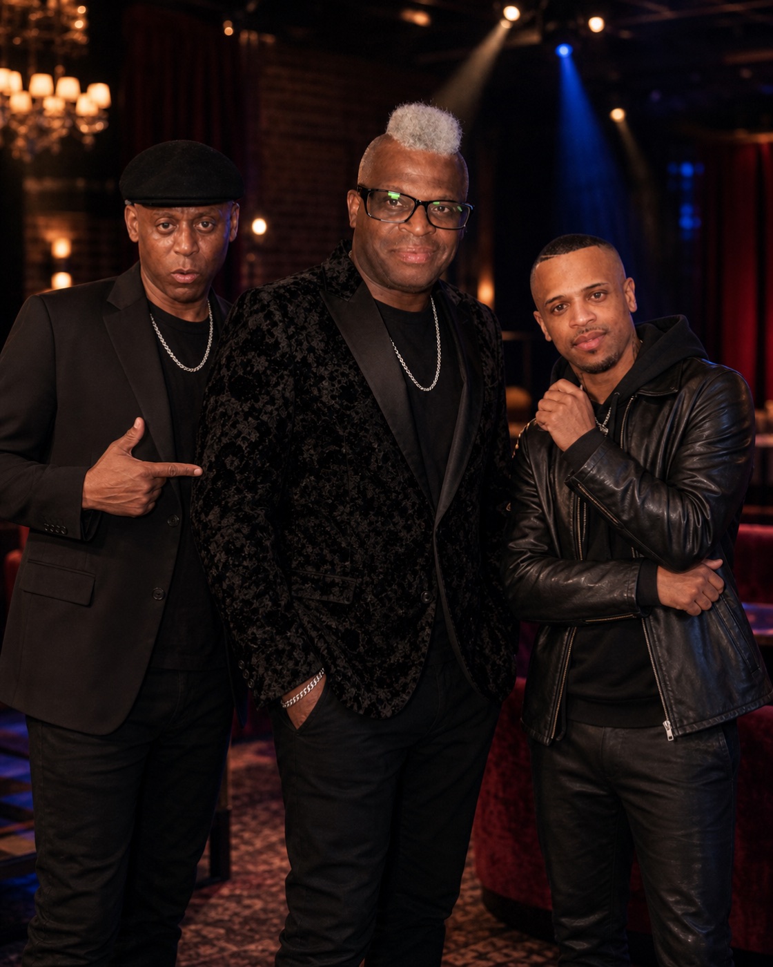 J-Dab, Khalil Mack, and Paris posed inside a warm lounge venue.